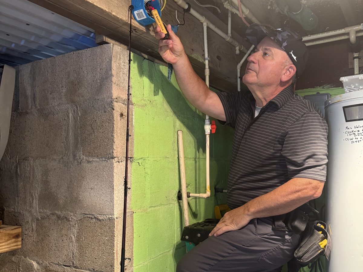 Jeff Pearce testing equipment at a utility panel