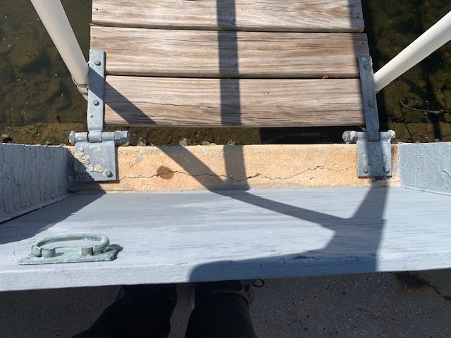 Cracked concrete cap beneath a gangway hinge