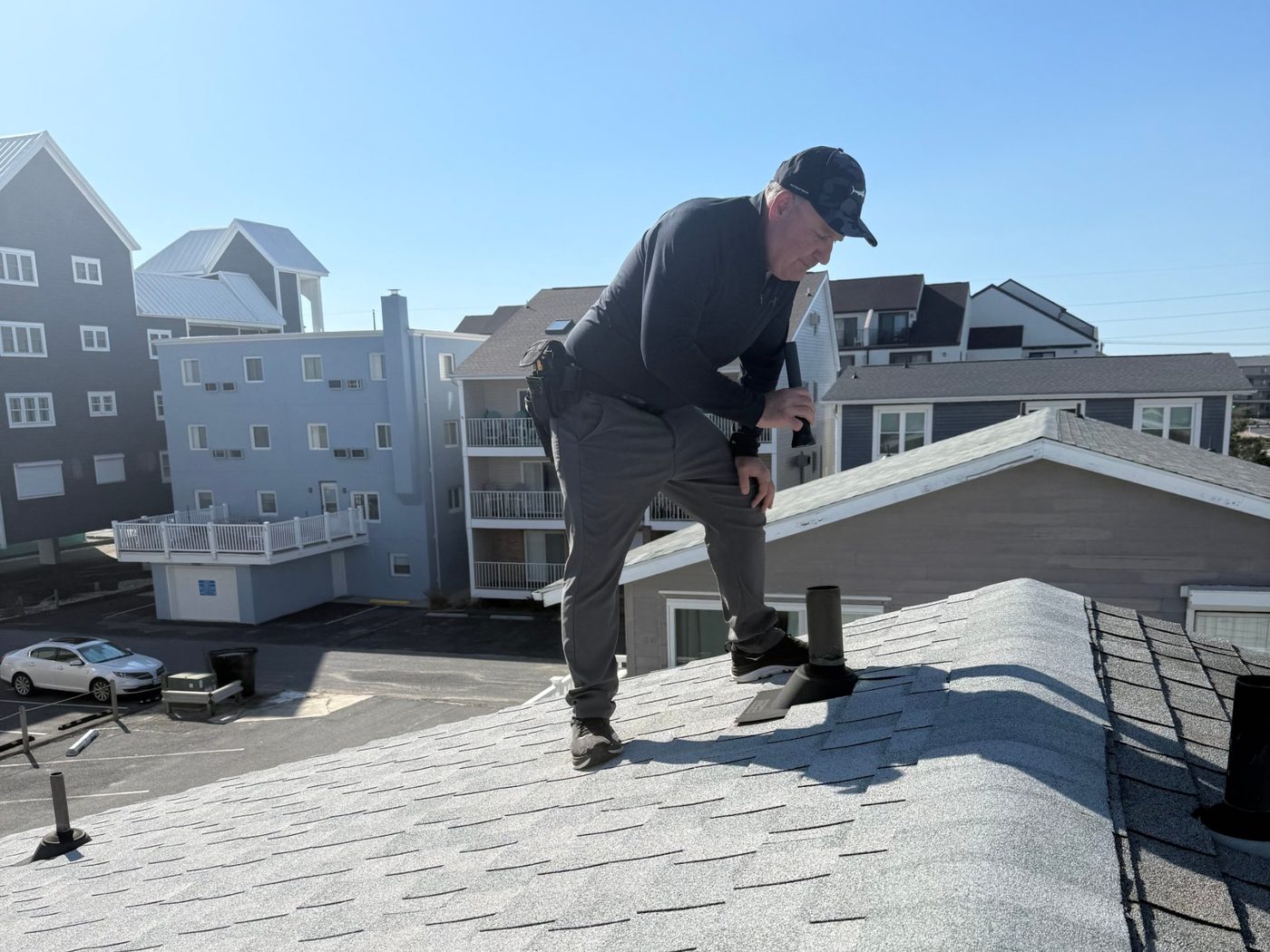 Jeff Pearce inspecting a roof vent with a flashlight